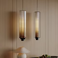Cylindrical Glass Pendant Lights With Warm Yellow Light On Wooden Wall