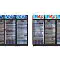 Commercial Display Refrigerators Stocked With Bottled Drinks And Coca-Cola Stickers