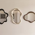Three Abstract Shaped Decorative Mirrors in Black Beige and Brown Hanging on White Wall