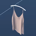 Beige Camisole Hanging on Rope with White Hanger Against Dark Blue Background
