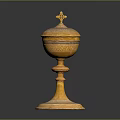 Yellow Carved Sculpture Vessel With Intricate Patterns And Cross Topped Lid On Pedestal Base