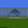 Industrial Factory Building With Large Glass Walls Front Entrance Green Lawn And Blue Sky Background