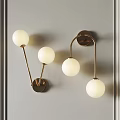 Modern Gold Metal Wall Lamps with White Globe Shades Mounted on Gray Wall