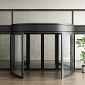 Modern Revolving Door Design With Glass Panels Black Frame Wooden Floor And Green Plant