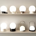 Modern Table Lamps With Spherical Shades And Various Base Designs On Shelves