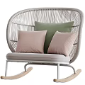Woven Rattan Leisure Rocking Chair With Green And Beige Pillows And White Frame