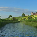 Scenic River Landscape With Green Grass Trees Small Houses And Clouds Under Blue Sky