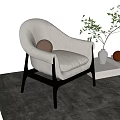 Light Colored Modern Leisure Chair With Black Wooden Legs Green Plant And Gray Rug