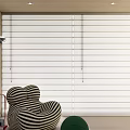 Modern Room Interior Featuring White Roman Blinds With Striped Armchair And Green Side Table