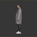 Man Wearing Grey Long Coat Black T-shirt Dark Pants And White Sneakers On Grey Background