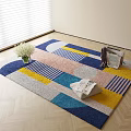 Square Area Rug Featuring Geometric Patterns Blue Pink Yellow Gray Tones On Wooden Floor