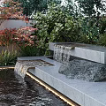 Garden Water Fountain With Cascading Waterfall Stone Pool Steps And Lush Greenery