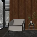 Modern Beige Armchair with Black Metal Frame by Wooden Wall and Side Table with Vase