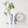 Blue And White Floral Pattern Ceramic Vase Plate Jar With Green Plant On White Tabletop