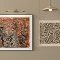 Abstract And Geometric Artwork Hanging On Beige Wall With Pendant Lamp