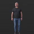 Man Wearing Black T shirt And Blue Jeans Standing Against Black Background Full Body View