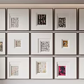 Multiple Framed Abstract Paintings With Diverse Artistic Designs On Wall