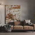 Brown Three-Seater Sofa with Gray Blanket Pillow Abstract Painting Floor Lamp and Green Plant
