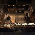 Cozy Roadside Bar with Outdoor Seating Tables Chairs and Warm Exterior Lighting Design