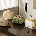 Colorful Toasters As Kitchen Appliances On Counter With Toasted Bread