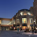 Commercial Street Evening Scene With Domed Building Large Glass Windows People Walking Benches Street Lamps