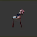 Colorful Stacked Clothes on Red Wooden Chair with T-shirts and Towels against Dark Background