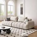 Beige Three-Seater Sofa With Plush Rounded Cushions White Walls Windows And Round Coffee Table