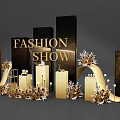 Floral Installation for Fashion Show with Gold Black Columns and Decorative Elements