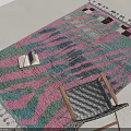 Leisure Chair On Colorful Patterned Rug With Tassels And Stack Of Books In Bright Interior