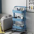 Practical Blue Rolling Shelf Cart For Living Room With Books Frames Globe And Baskets 3d model