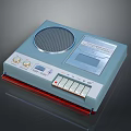 Vintage Computer Peripheral Featuring Light Blue Casing Speaker Grill And Control Buttons