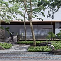 Modern Residential Landscape Entrance Featuring Stone Steps Sculpture And Lush Green Plants