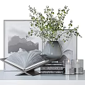 Decorative Ornament Set With Open Book Stacked Books Gray Vase Green Foliage And Framed Artwork