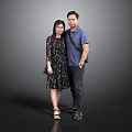 Man In Blue Shirt And Woman In Floral Dress Standing In Gray Background