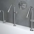 Sleek Modern Stainless Steel Faucets With Different Heights On White Countertop Grey Wall