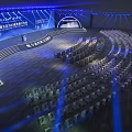 Modern Large Conference Venue With Stage Arranged Seats And Blue Lighting
