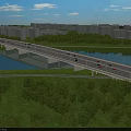 Scenic Bridge Over River With Vehicles Green Grass Trees And High Rise Buildings