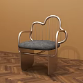 Cloud Shaped Metal Leisure Chair With Gray Padded Seat And Armrests On Wooden Herringbone Floor