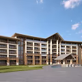 Contemporary Multi Story Hotel Building Featuring Wooden Stone Exterior Large Windows And Green Lawn Entrance