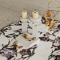 Decorative Ornament Set With White Candle Holders Lit Candles Nuts On Books And Dried Flowers