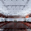 Religious Church Interior Featuring Wooden Pews Stained Glass Windows Two Level Balconies And Chandeliers