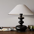 Black Table Lamp with White Lampshade Open Book Camera and Moss Container on Wooden Table