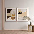Two Abstract Paintings With Neutral Tones Hanging On Wall And Wooden Stool With Dried Plants