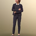Woman in Dark Professional Suit Standing with Arms Crossed Over Chest Against Beige Background