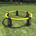 Yellow Circular Spark Tube Play Equipment on Green Grass with Black Supports