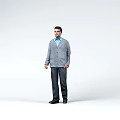 Man Against White Background Wearing Gray Cardigan Light Blue Shirt Dark Pants And Black Shoes