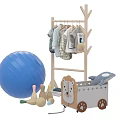 Children's Casual Clothes on Wooden Clothes Rack with Blue Exercise Ball and Lion Toy Box