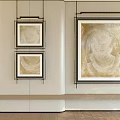 Three Black Framed Gold And Beige Modern Oil Paintings On White Wall With Wooden Floor
