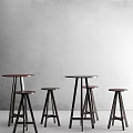 Minimalist Bar Counter Design With Wooden Stools In Various Heights And Gray Wall Background