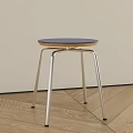 Modern Minimalist Stool With Blue Round Seat And Silver Metal Legs On Wooden Floor